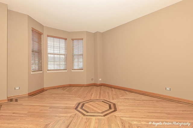 empty room with parquet flooring and baseboards