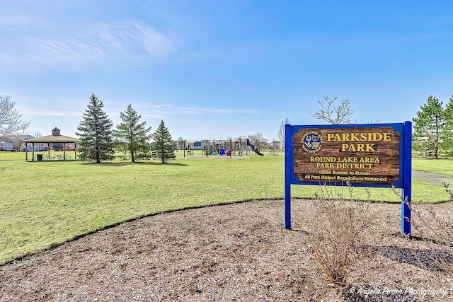 view of property's community with a gazebo, playground community, and a yard