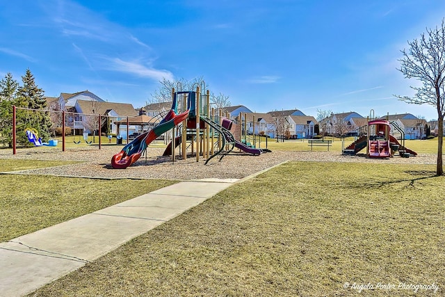 community jungle gym with a residential view and a yard