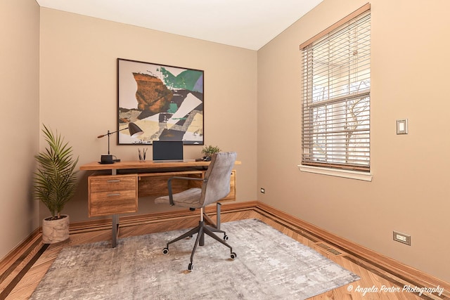 office area with baseboards and wood finished floors