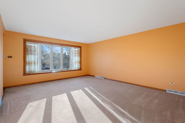 empty room with visible vents and baseboards