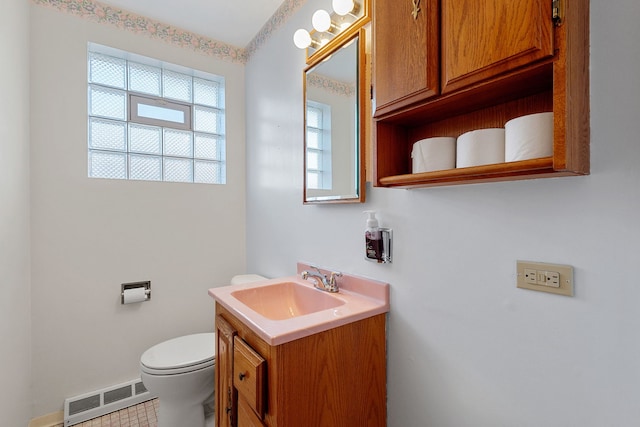 bathroom featuring visible vents, toilet, and vanity