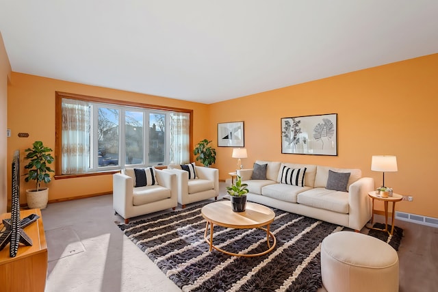 living area featuring visible vents, carpet, and baseboards