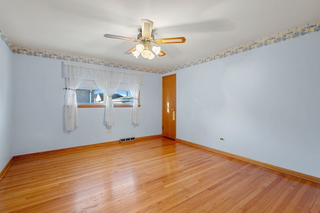 unfurnished room with visible vents, light wood-style flooring, baseboards, and ceiling fan