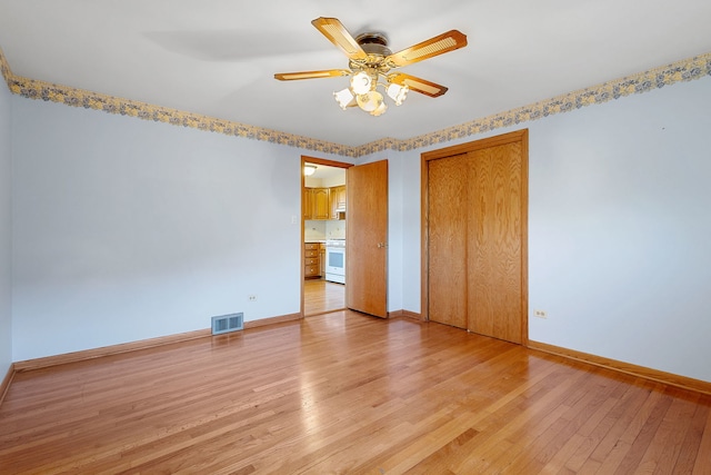 unfurnished bedroom with visible vents, a ceiling fan, a closet, light wood finished floors, and baseboards