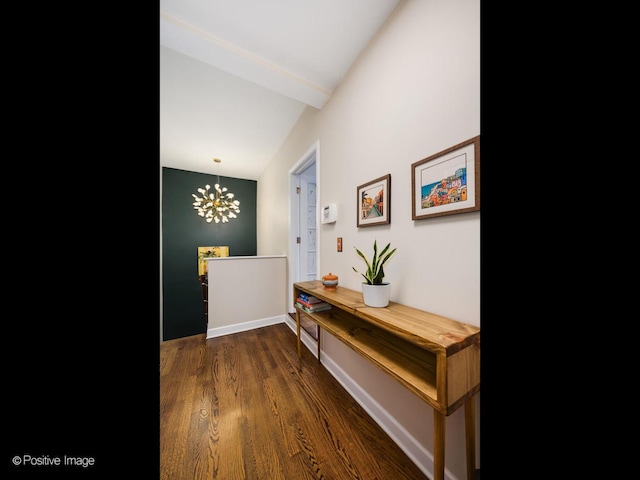 hallway featuring an inviting chandelier, dark wood-type flooring, and beam ceiling