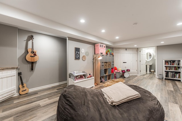 interior space featuring recessed lighting, baseboards, and wood finished floors