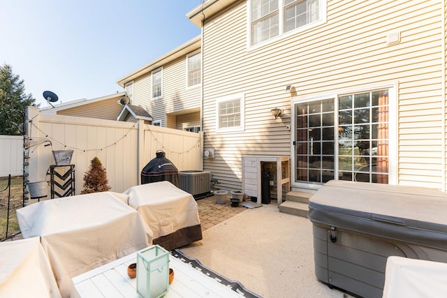 view of patio / terrace with entry steps, central AC, and fence