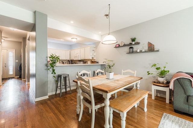 dining area featuring recessed lighting, wood finished floors, and baseboards