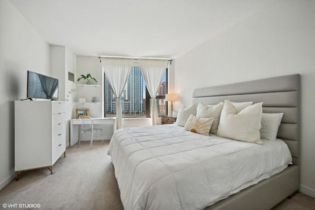 bedroom featuring carpet and baseboards