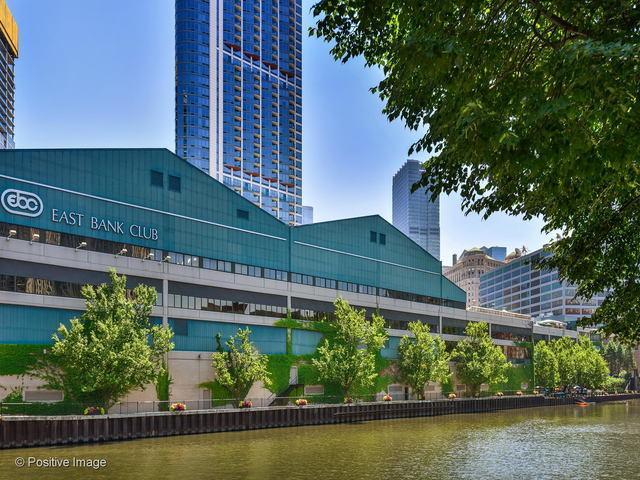 view of building exterior with a water view and a city view