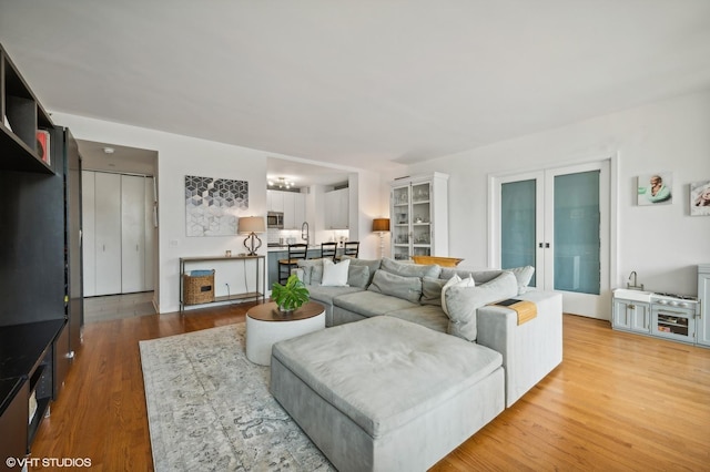 living area with wood finished floors and french doors