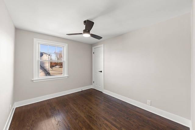 unfurnished room featuring baseboards, ceiling fan, and dark wood-style flooring