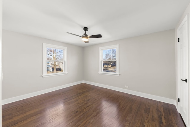 unfurnished room with ceiling fan, baseboards, and dark wood finished floors