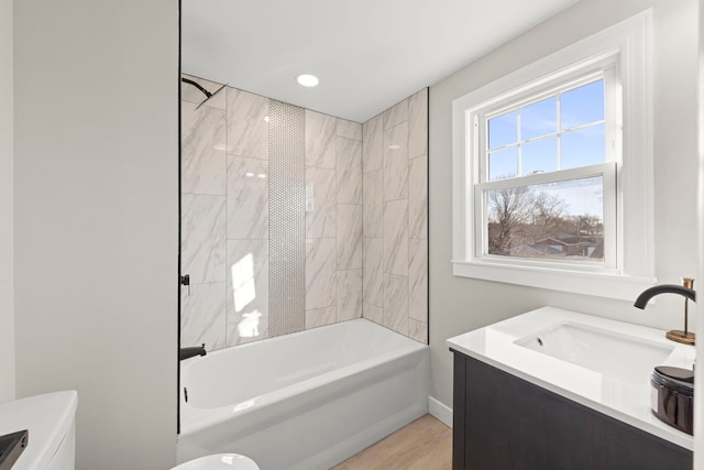 full bath featuring toilet, vanity, and washtub / shower combination