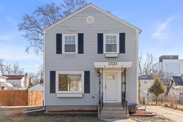 view of front of home featuring entry steps and fence