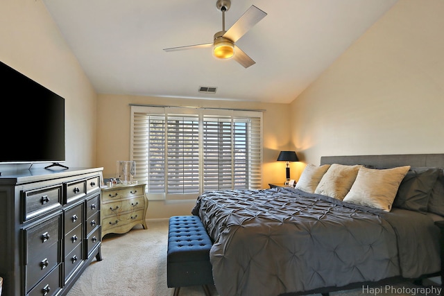 bedroom with visible vents, baseboards, lofted ceiling, light carpet, and a ceiling fan