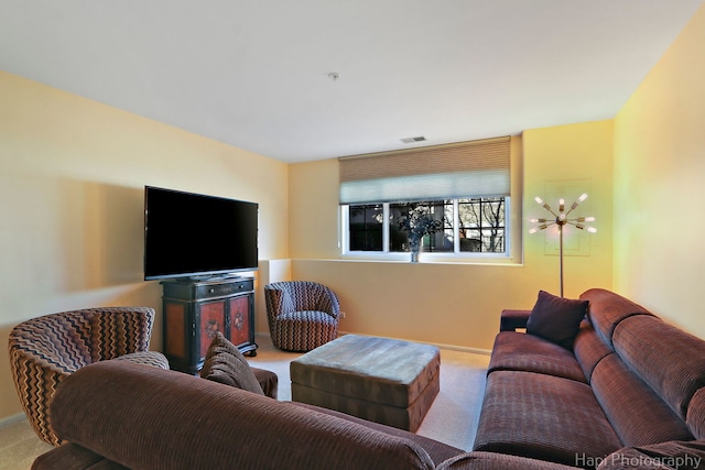 carpeted living area with visible vents and baseboards