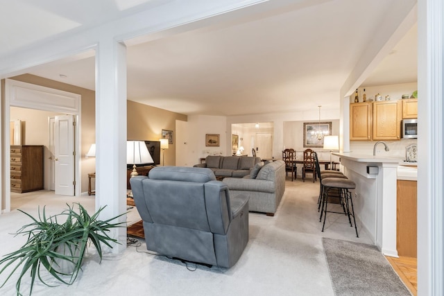 13536 Westridge Ct, Huntley, IL 60142 - living room featuring light colored carpet and an inviting chandelier