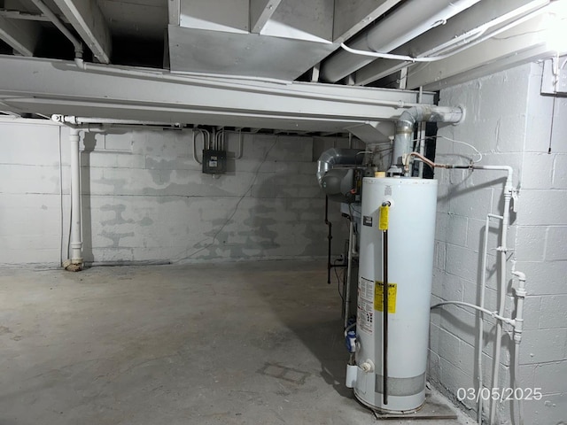 unfinished below grade area featuring water heater