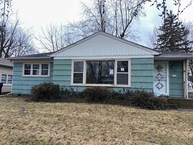 view of side of home with a lawn