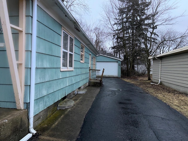 view of side of property with an outbuilding and a garage