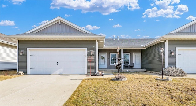 ranch-style house with a garage, driveway, and roof with shingles