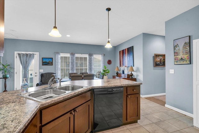 kitchen featuring baseboards, dishwasher, pendant lighting, brown cabinets, and a sink