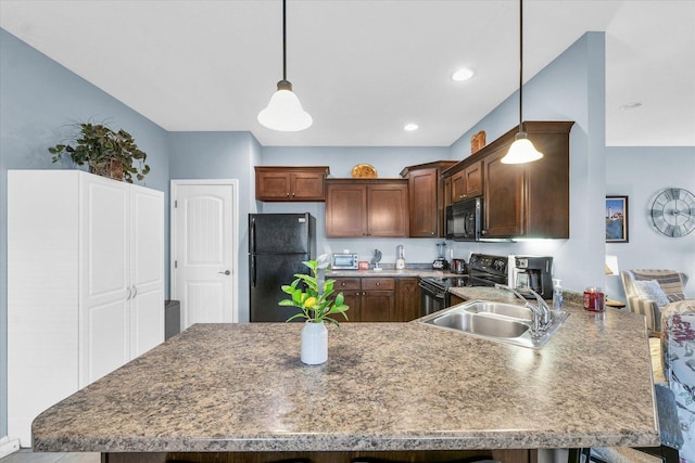 kitchen featuring a sink, black appliances, a peninsula, and pendant lighting