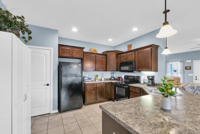 kitchen with black appliances, decorative light fixtures, light tile patterned flooring, and recessed lighting