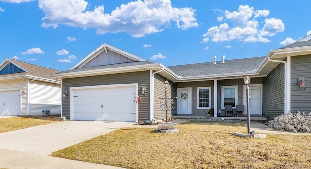 single story home featuring a front yard, roof with shingles, an attached garage, concrete driveway, and board and batten siding