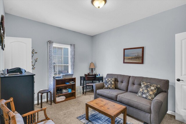 carpeted living room featuring baseboards