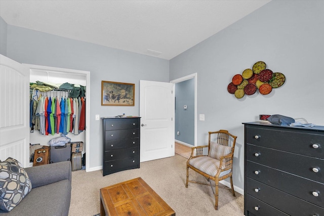 interior space featuring a closet, a spacious closet, baseboards, and carpet