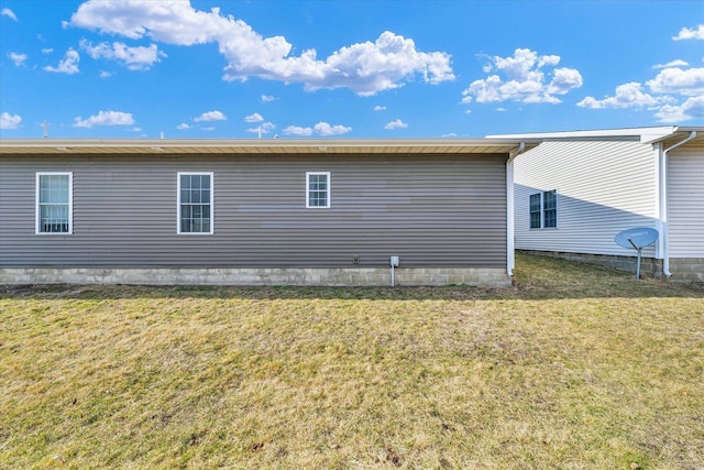 view of side of home featuring a lawn