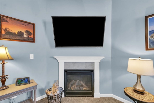 carpeted living room with a fireplace and baseboards