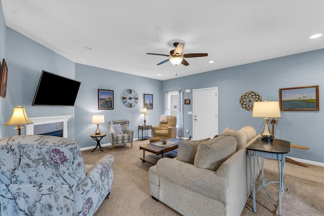 carpeted living room featuring recessed lighting, a tile fireplace, baseboards, and ceiling fan