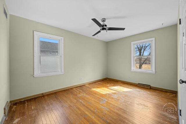 interior space featuring hardwood / wood-style flooring, baseboards, and visible vents