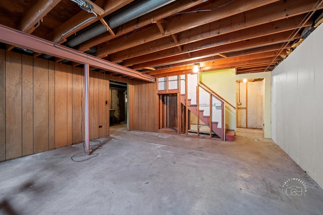 unfinished basement featuring stairs