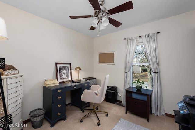 office featuring baseboards, light carpet, and ceiling fan