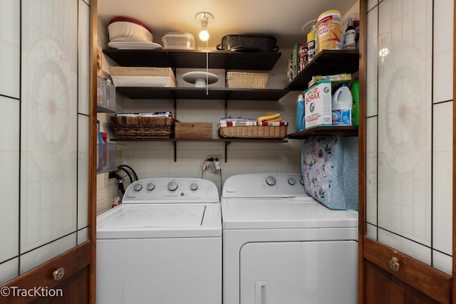 washroom with independent washer and dryer and laundry area