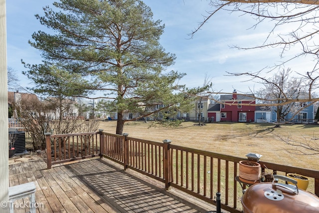 wooden deck featuring a residential view and a lawn