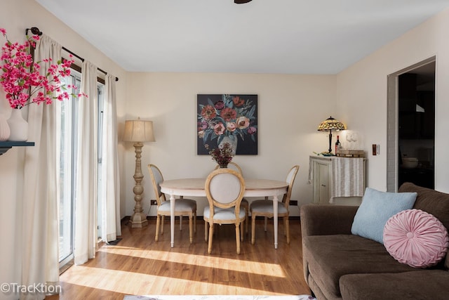 dining area with plenty of natural light and wood finished floors