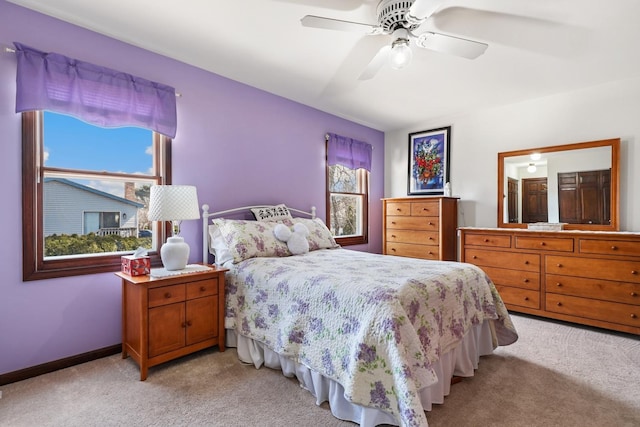 bedroom with baseboards, light carpet, and a ceiling fan