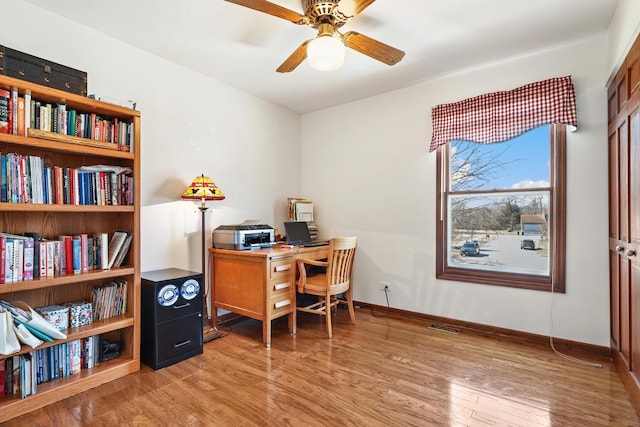 office space featuring ceiling fan, visible vents, baseboards, and light wood-style flooring