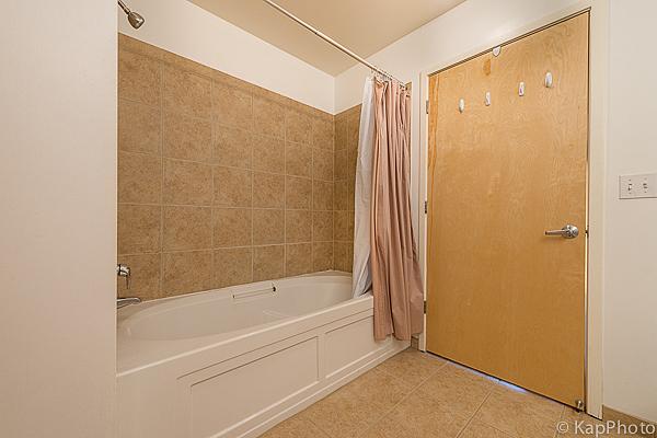 bathroom featuring shower / bath combination with curtain and tile patterned floors