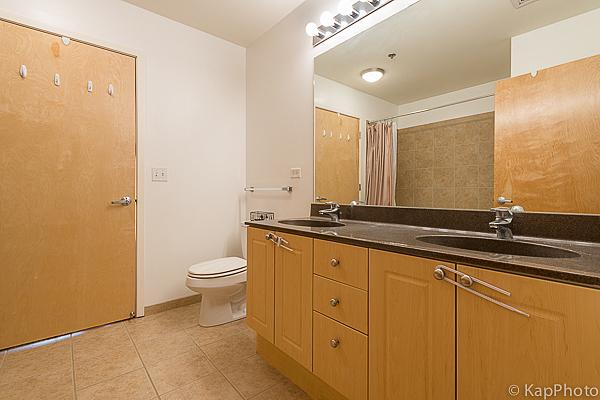 full bath featuring a sink, toilet, double vanity, and tile patterned flooring