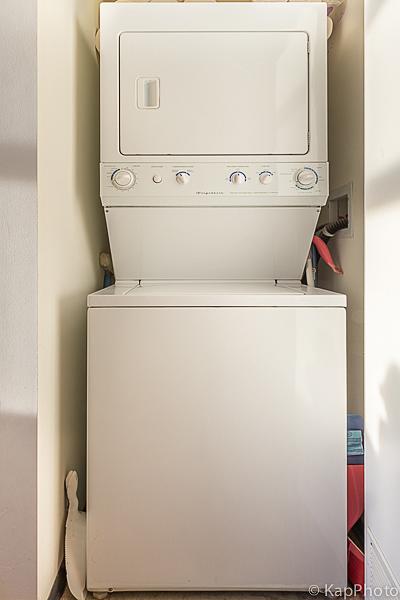 laundry room with laundry area and stacked washer / dryer