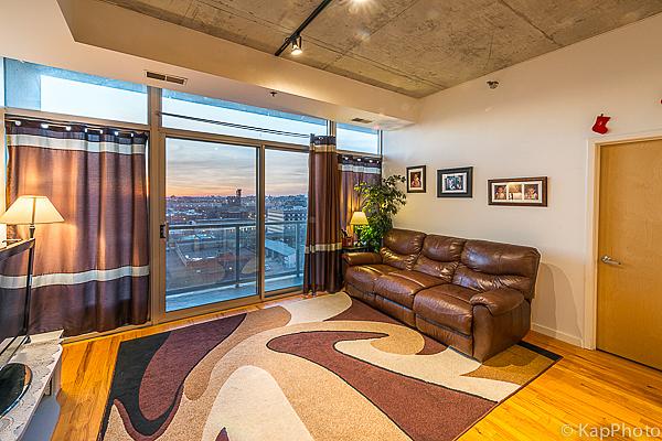 living room with track lighting, wood finished floors, and visible vents