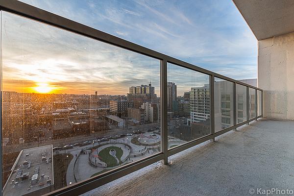 balcony at dusk featuring a view of city