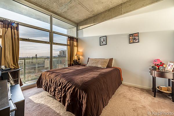 bedroom featuring a wall of windows, baseboards, and carpet floors